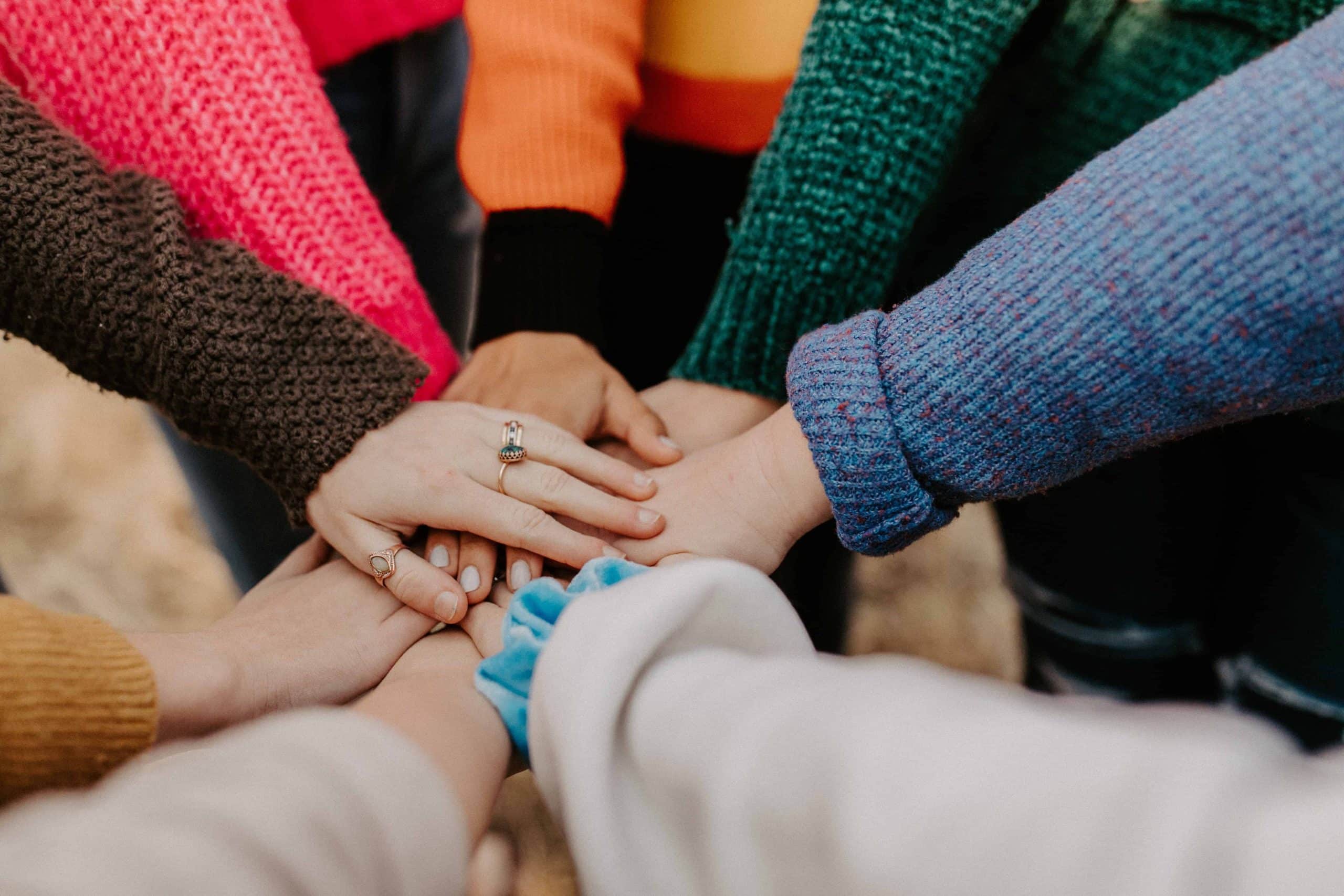 Group of hands placed in a united form