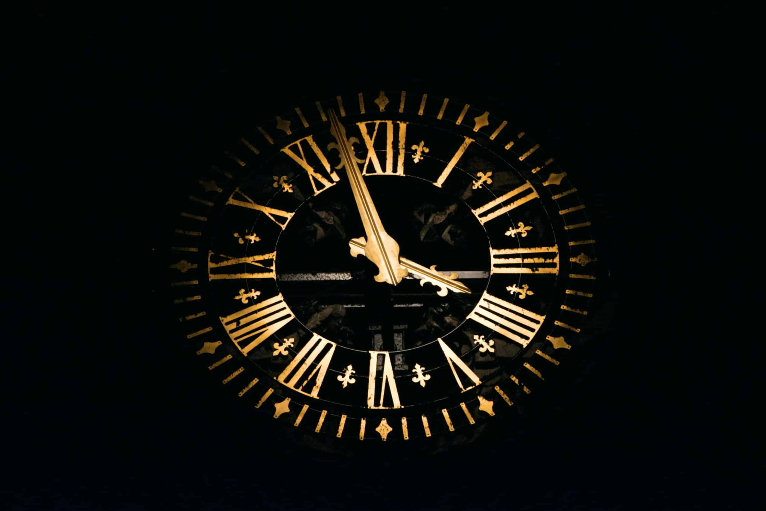 A large clock face with gold Roman numerals and clock hands shows the time as approximately 11:55 against a dark background, symbolizing the importance of timely decisions in Xero cash flow management.